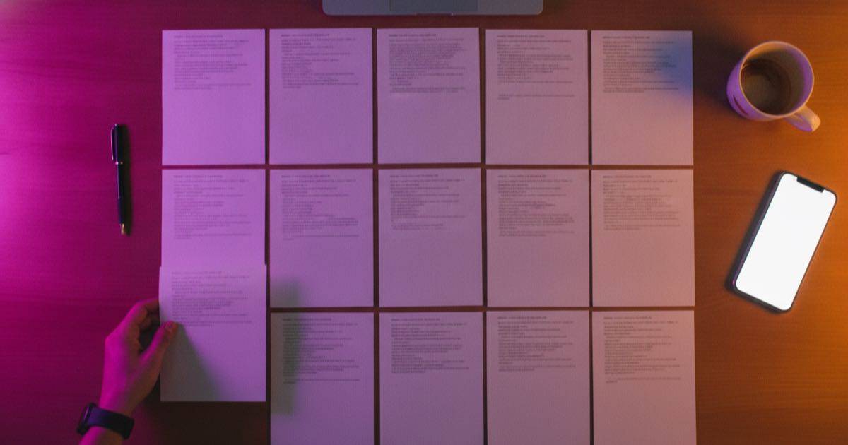 A digital prompt pack laid out as printed template sheets on a desk lit with an Instagram-style gradient